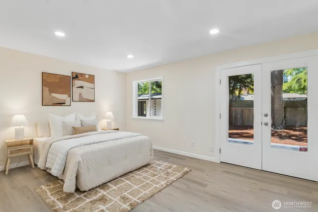 a bedroom with a large bed and a window