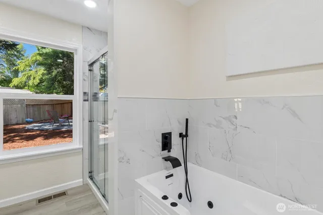 a bathroom with a bathtub and a shower