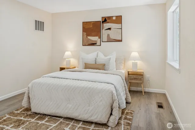 a bedroom with a bed and a night stand