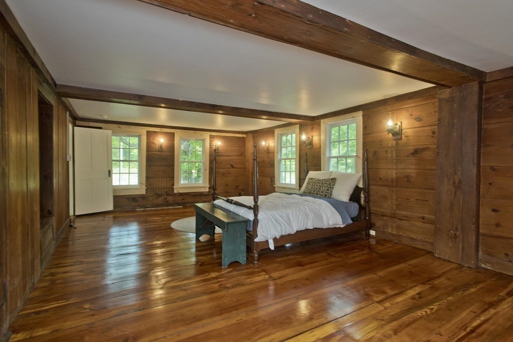 621 Amherst Road Sunderland, MA 01375 - Photo 20 of 42 a bedroom with a bed and wooden floor