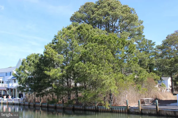 a view of residential houses with outdoor space and lake view