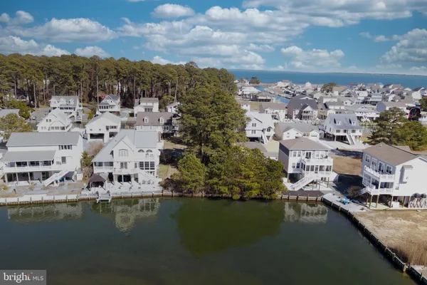 a view of residential houses with outdoor space and lake view