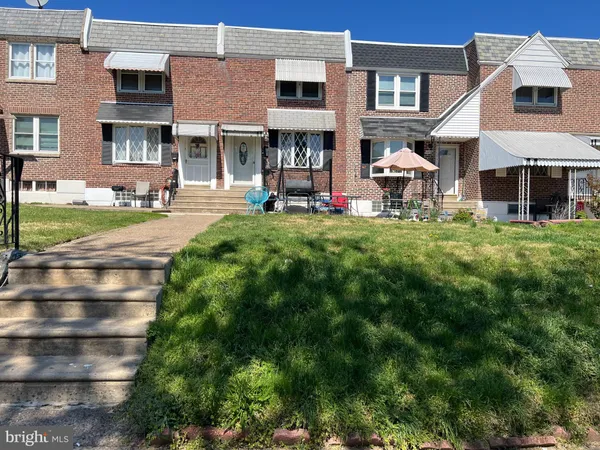 a front view of a residential apartment building with a yard