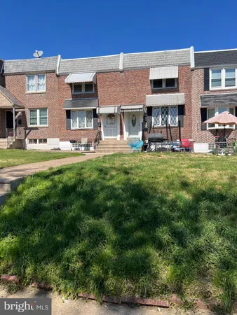 a view of the house with a yard