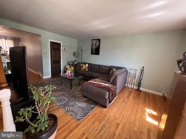 a living room with furniture rug and wooden floor