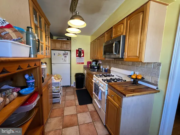 a kitchen with stainless steel appliances granite countertop a stove and a refrigerator