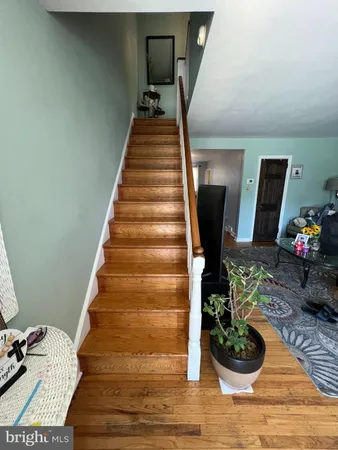 a view of entryway and hall with wooden floor