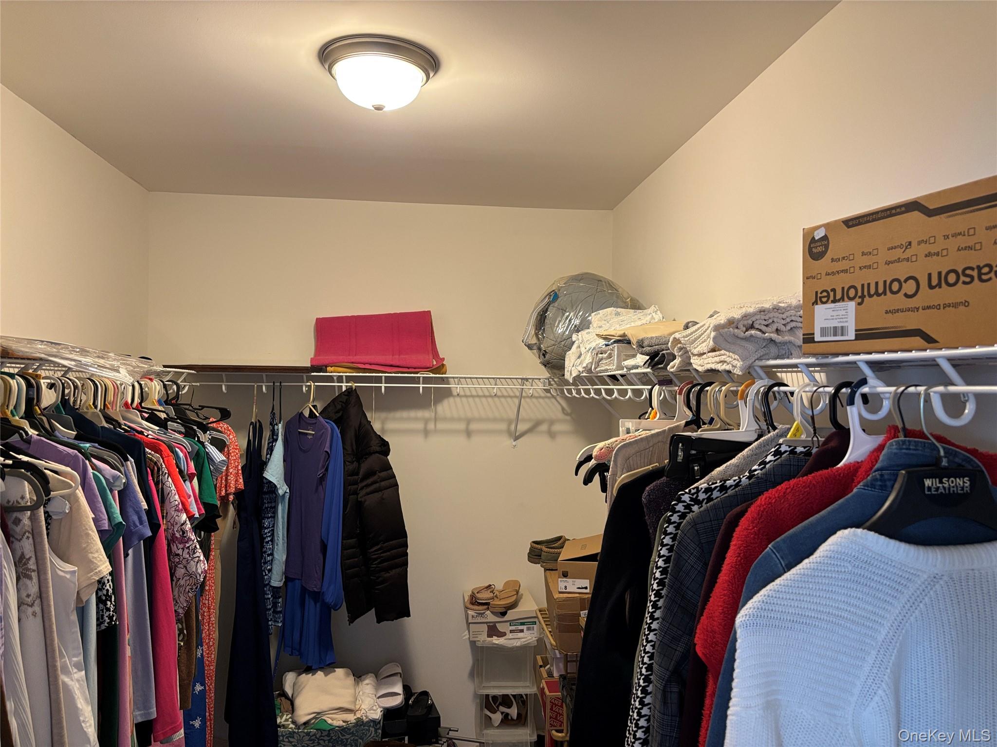 1661 Old Country Road, Unit 563 Riverhead, NY 11901 - Photo 34 of 43 a view of walk in closet with clothes