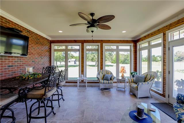 4305 Cedar Grove Road Murfreesboro, TN 37127 - Photo 12 of 20 Here's where you'll spend a lot of time catching a game on TV, having a party, or just reading a book & enjoying all the windows looking over your property! This room is heated/cooled w/crank-out windows, large tile floors & brick walls!