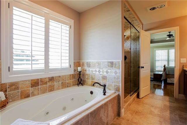 4305 Cedar Grove Road Murfreesboro, TN 37127 - Photo 14 of 20 The Owner Suite Bath has a wonderful separate whirlpool tub and large tile shower with Travertine tile floor. The Owner Suite closet is next to the Bath!