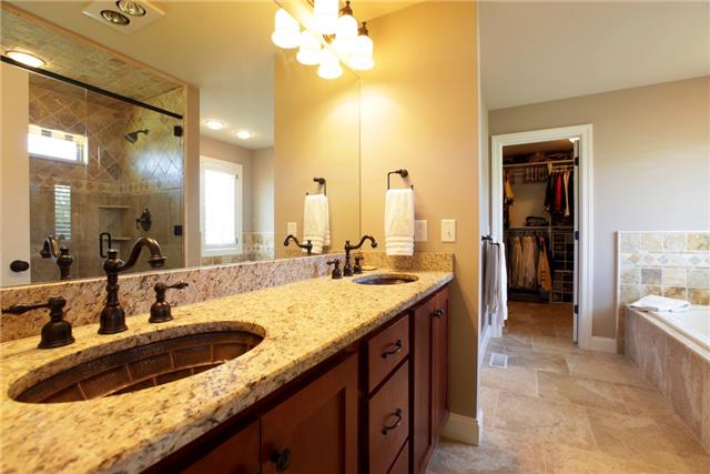 4305 Cedar Grove Road Murfreesboro, TN 37127 - Photo 15 of 20 Another view of the Owner Suite Bath with copper sinks and Venetian Bronze fixtures. The 11x8 Laundry Room is next to the closet with cabinets & sink, also serving as a Mud Room leading to the attached 2-car garage!