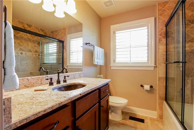 4305 Cedar Grove Road Murfreesboro, TN 37127 - Photo 17 of 20 A full Bath is located near Bedrooms #2 & #3. This room is gorgeous with Travertine tile floor, tile shower, copper sink and Venetian Bronze fixtures!