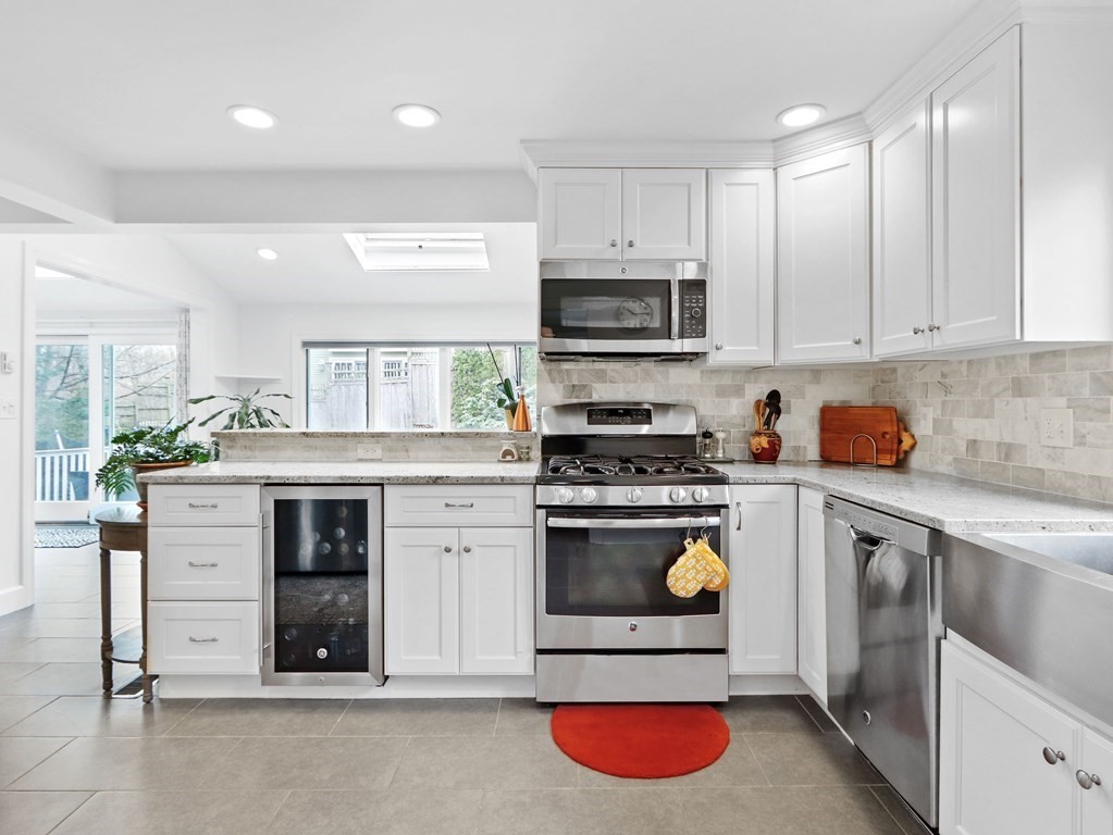 40 Whittier Road Newton, MA 02460 - Photo 7 of 20 a kitchen with stainless steel appliances granite countertop a stove a sink and a refrigerator