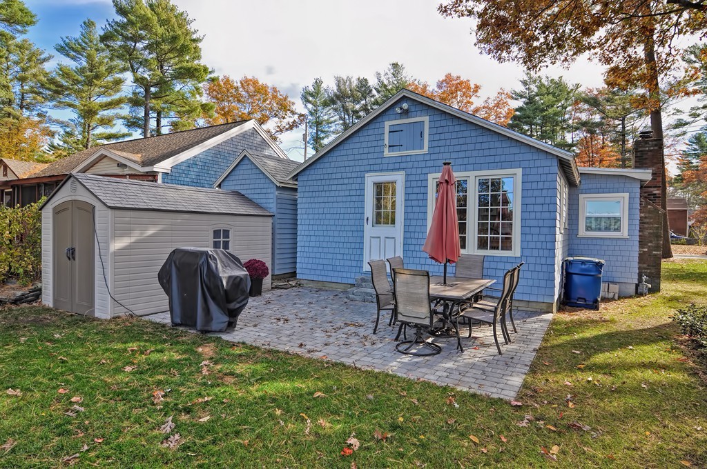 55 Evergreen Road Norton, MA 02766 - Photo 17 of 21 a view of a backyard with table and chairs and a fire pit