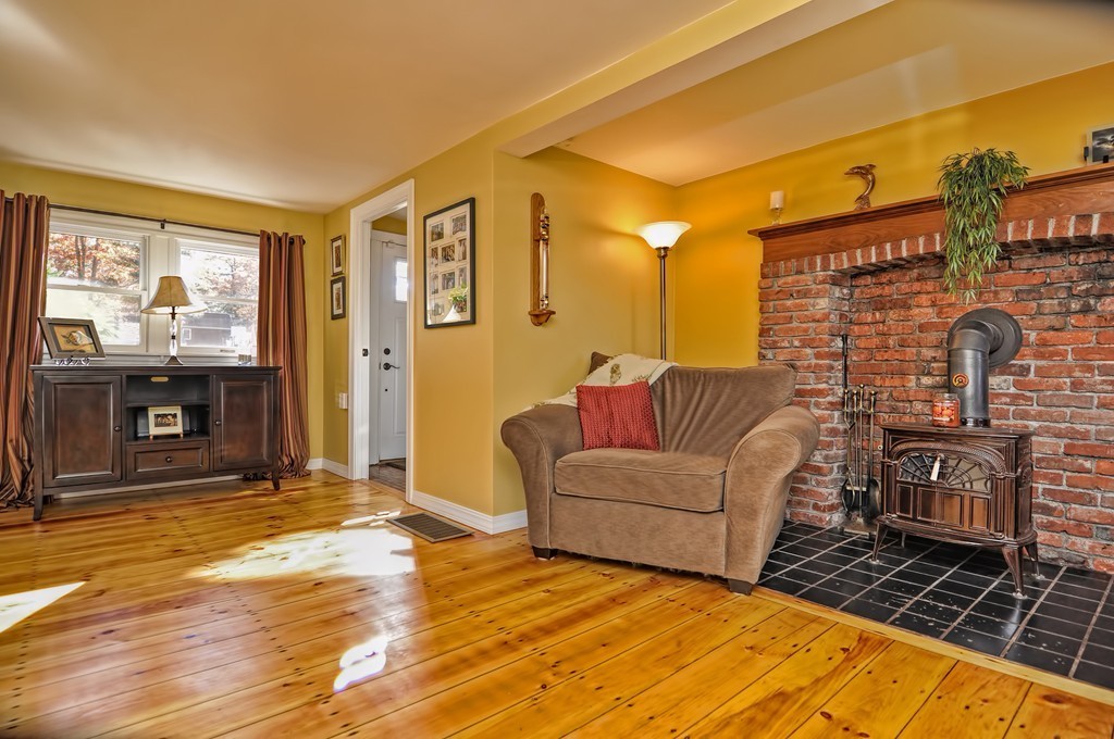 55 Evergreen Road Norton, MA 02766 - Photo 4 of 21 a living room with furniture a window and a fireplace