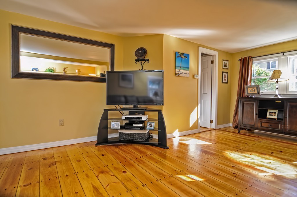 55 Evergreen Road Norton, MA 02766 - Photo 7 of 21 a bedroom with a bed and wooden floor