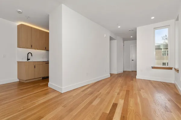 a view of a room with wooden floor and cabinet