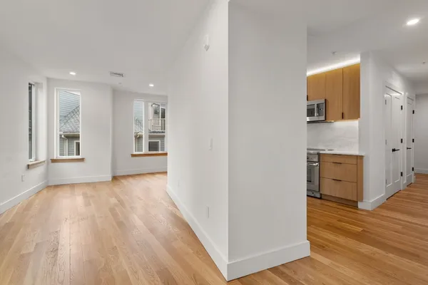 a view of a kitchen with wooden floor and a sink