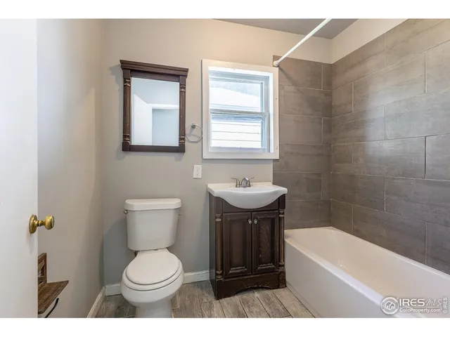 a bathroom with a toilet a sink and bathtub