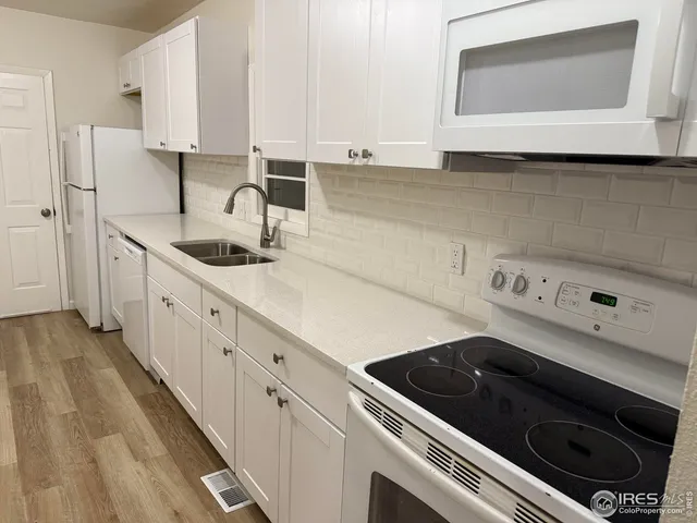a kitchen with a sink stove and cabinets