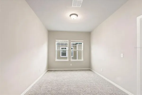 a kitchen with stainless steel appliances granite countertop white cabinets sink and window