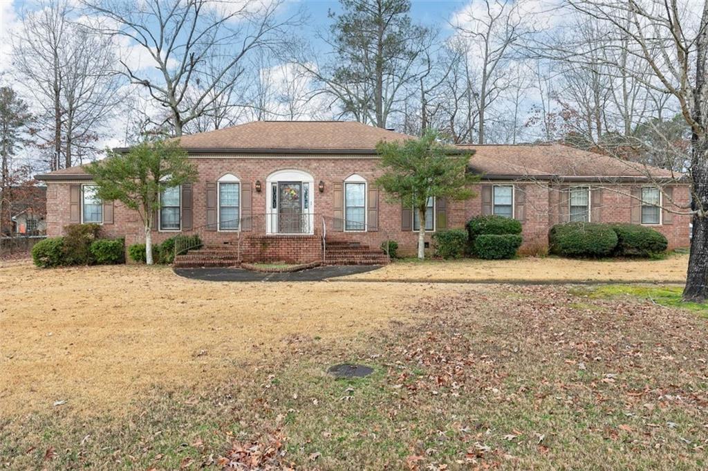 103 Windwood Way Rome, GA 30165 - Photo 1 of 1 a view of a house with a yard and plants