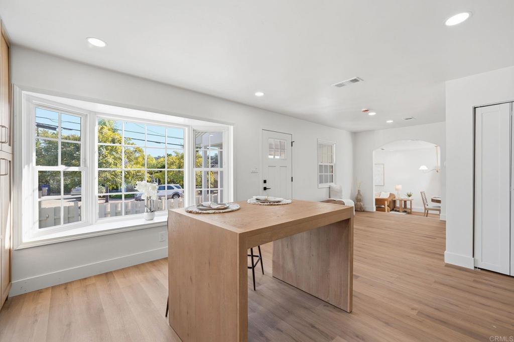 4920 Elsa Road San Diego, CA 92120 - Photo 12 of 46 a room with a table chairs and wooden floor