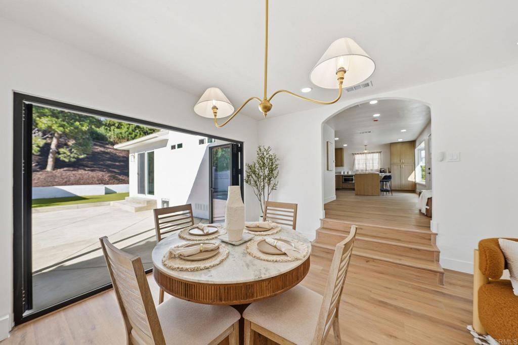 4920 Elsa Road San Diego, CA 92120 - Photo 20 of 46 a view of a dining room with furniture window and wooden floor