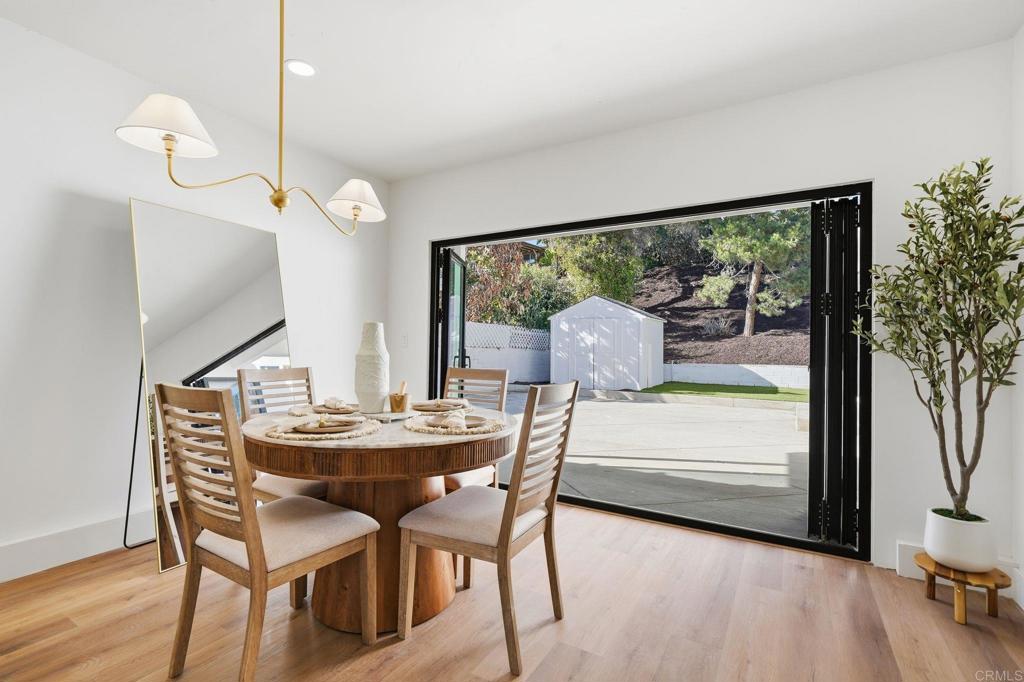 4920 Elsa Road San Diego, CA 92120 - Photo 21 of 46 a dining room with furniture and wooden floor