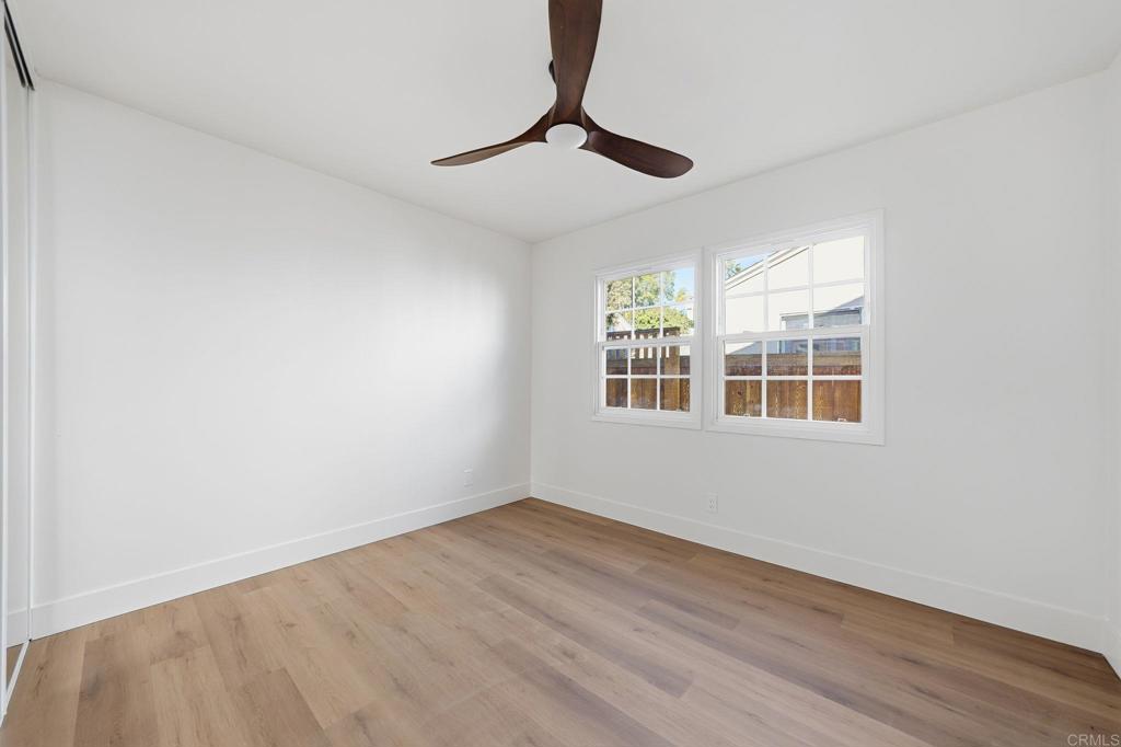 4920 Elsa Road San Diego, CA 92120 - Photo 26 of 46 a view of empty room with wooden floor and fan