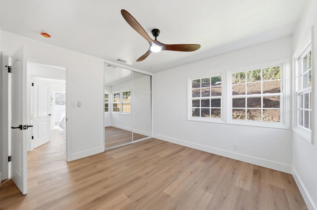 4920 Elsa Road San Diego, CA 92120 - Photo 29 of 46 a view of an empty room with wooden floor and a window
