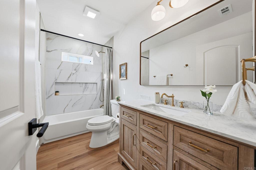 4920 Elsa Road San Diego, CA 92120 - Photo 30 of 46 a bathroom with a sink a toilet and shower