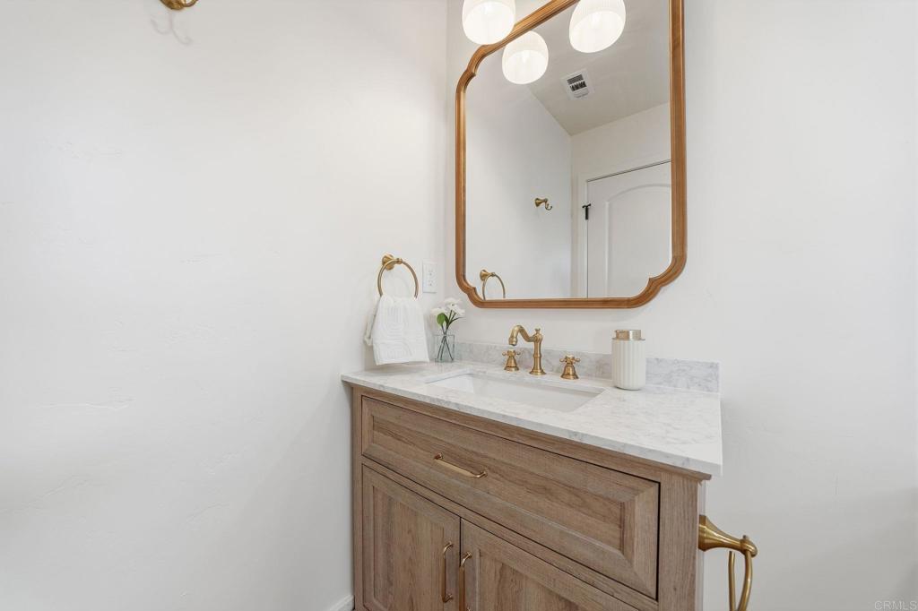 4920 Elsa Road San Diego, CA 92120 - Photo 33 of 46 a bathroom with a sink and a mirror