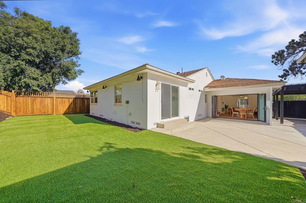 4920 Elsa Road San Diego, CA 92120 - Photo 38 of 46 a front view of a house with a garden and yard