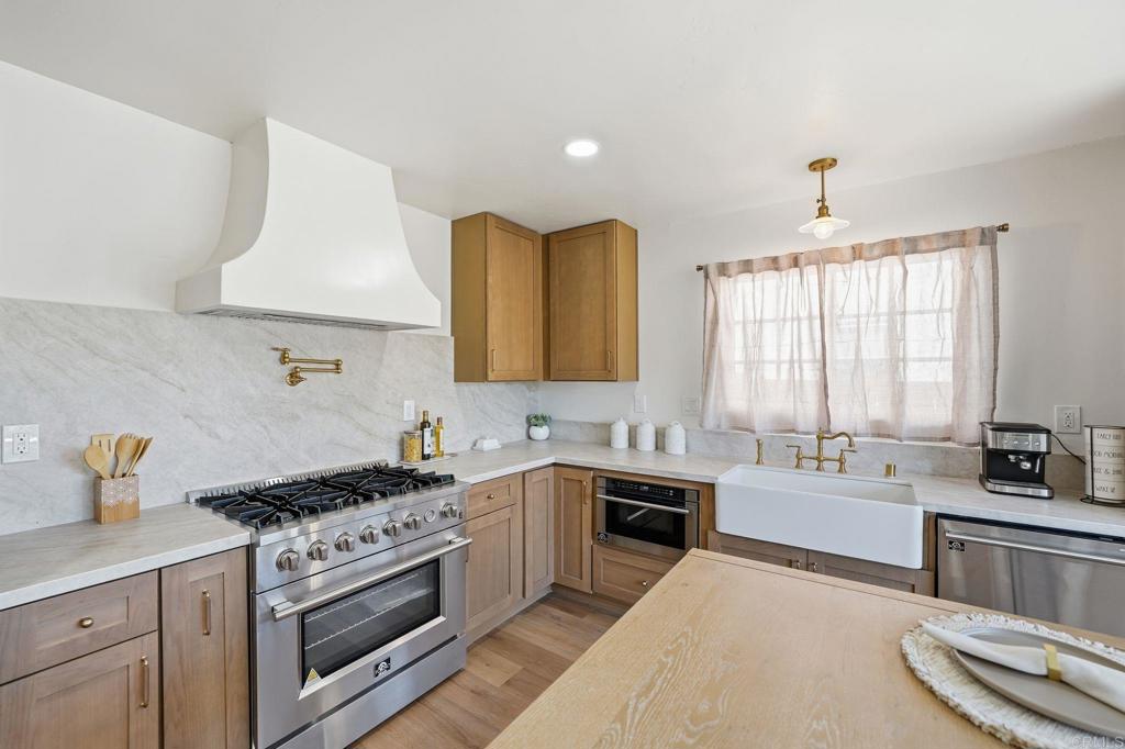 4920 Elsa Road San Diego, CA 92120 - Photo 5 of 46 a kitchen with a sink stove top oven and cabinets