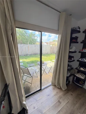 a view of a room with wooden floor and windows