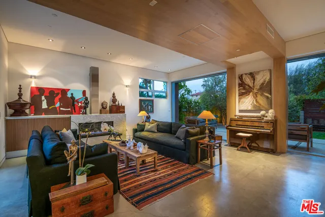 a living room with furniture a rug and a large window