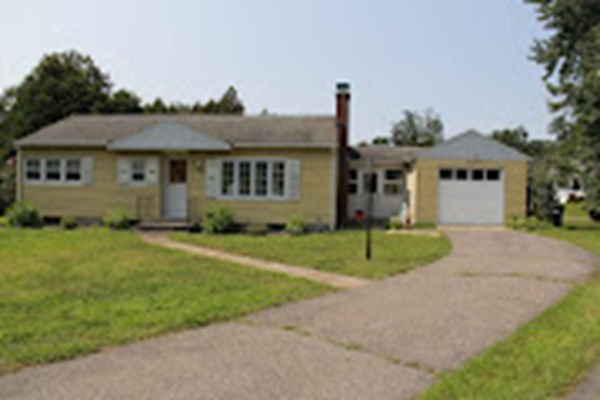 100 Bellwood Road Springfield, MA 01119 - Photo 1 of 24 a front view of a house with a yard and garage