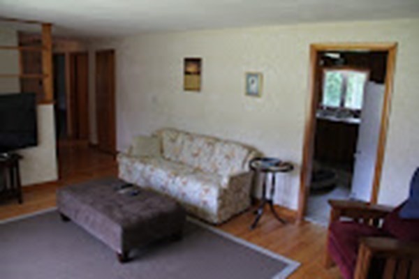 100 Bellwood Road Springfield, MA 01119 - Photo 6 of 24 a living room with furniture a flat screen tv and a refrigerator
