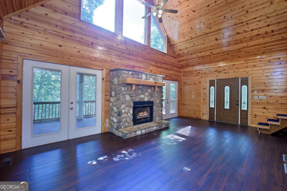 3373 Hardscrabble Road Mineral Bluff, GA 30559 - Photo 18 of 50 a living room with hard wood floors and a fireplace