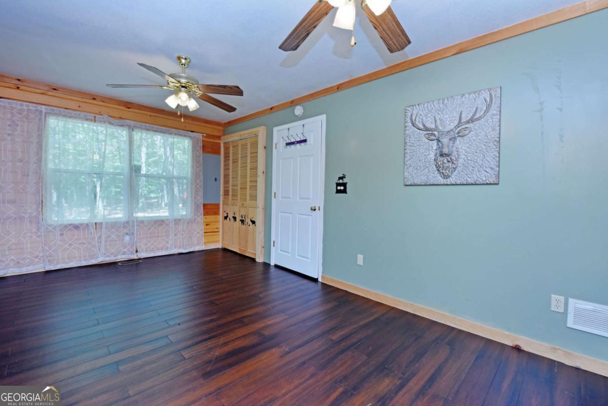 3373 Hardscrabble Road Mineral Bluff, GA 30559 - Photo 29 of 50 a view of an empty room with wooden floor and a window
