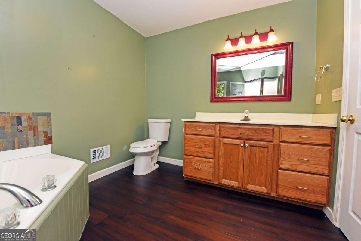 3373 Hardscrabble Road Mineral Bluff, GA 30559 - Photo 32 of 50 a bathroom with a toilet sink and mirror
