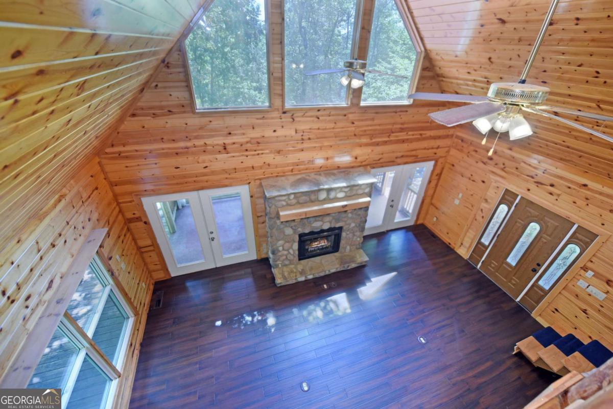 3373 Hardscrabble Road Mineral Bluff, GA 30559 - Photo 33 of 50 a living room with wooden floors and a fireplace