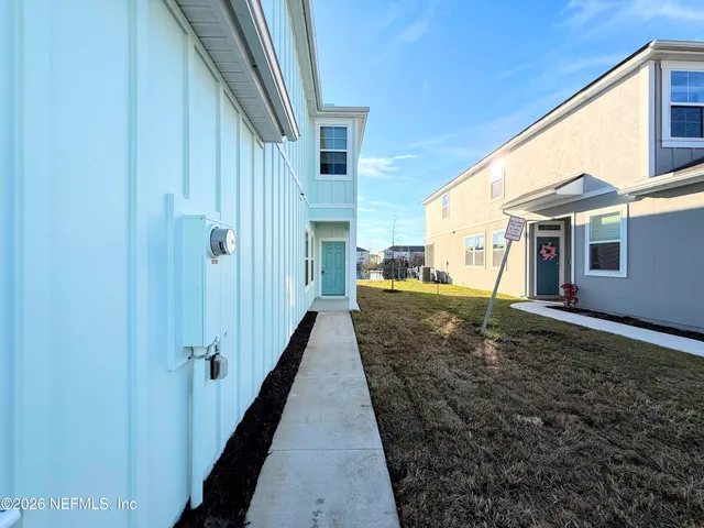 a view of a house with backyard and porch