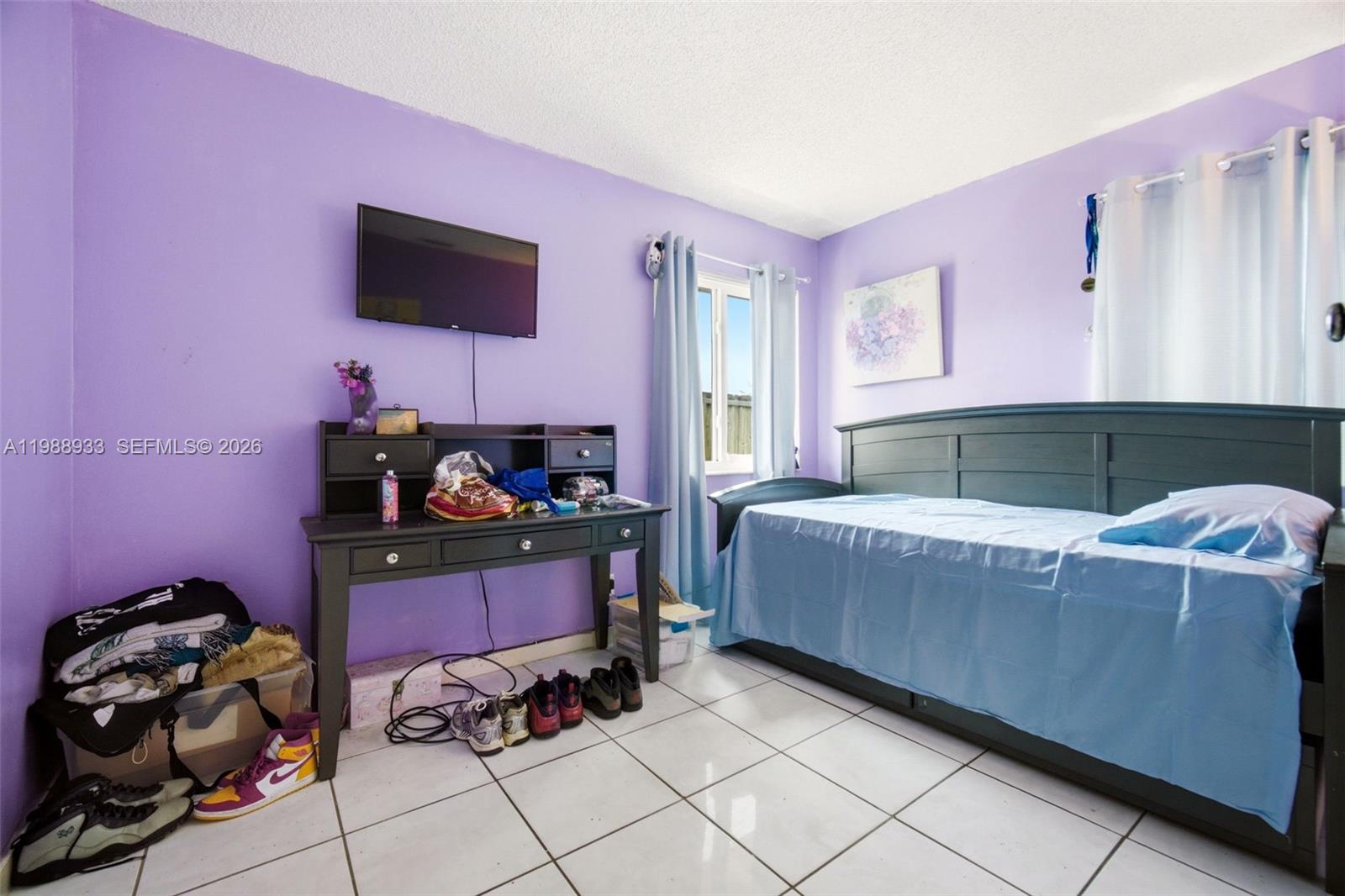 841 Southwest 55th Avenue Margate, FL 33068 - Photo 18 of 26 a bedroom with a bed and a tv