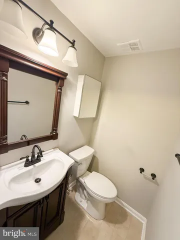a bathroom with a sink a toilet and mirror