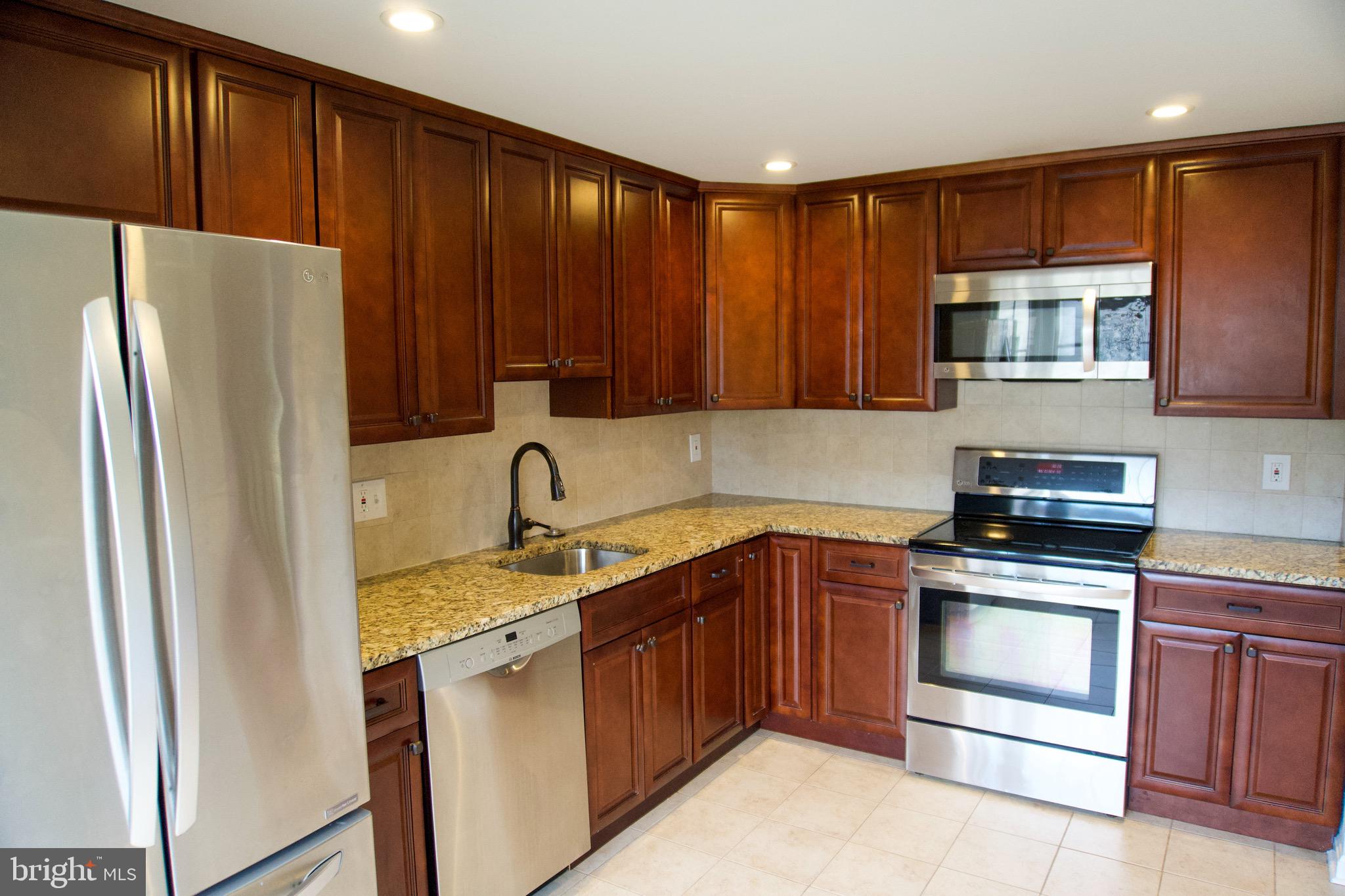 7341 Crestleigh Circle Alexandria, VA 22315 - Photo 5 of 21 a kitchen with a refrigerator sink and cabinets