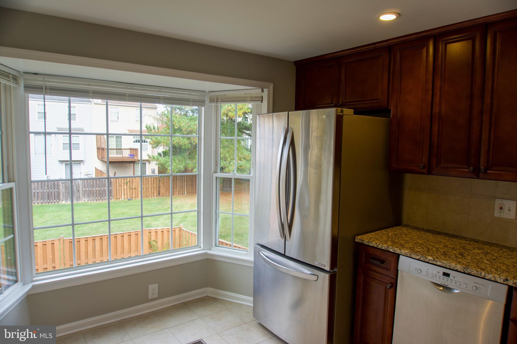 7341 Crestleigh Circle Alexandria, VA 22315 - Photo 7 of 21 a kitchen with stainless steel appliances granite countertop a refrigerator and a sink