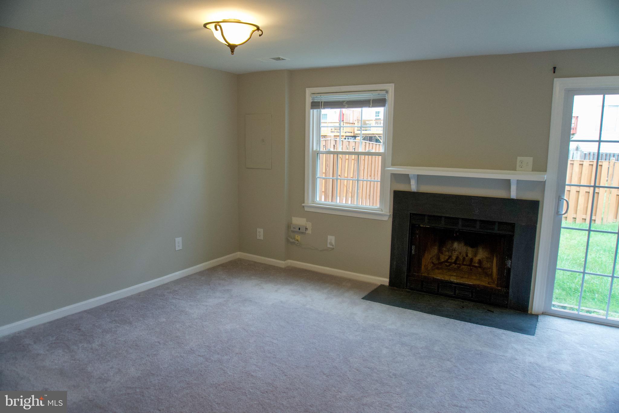 7341 Crestleigh Circle Alexandria, VA 22315 - Photo 10 of 21 an empty room with a fireplace and window