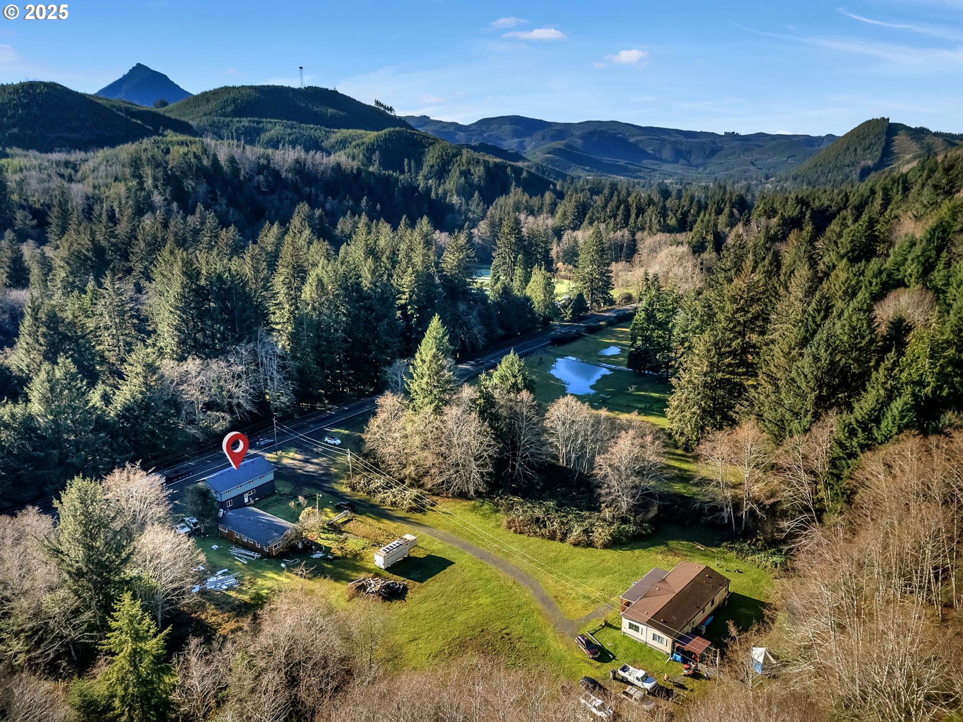 36375 Sunset Highway Seaside, OR 97138 - Photo 15 of 19 a backyard of a house with a yard and mountain